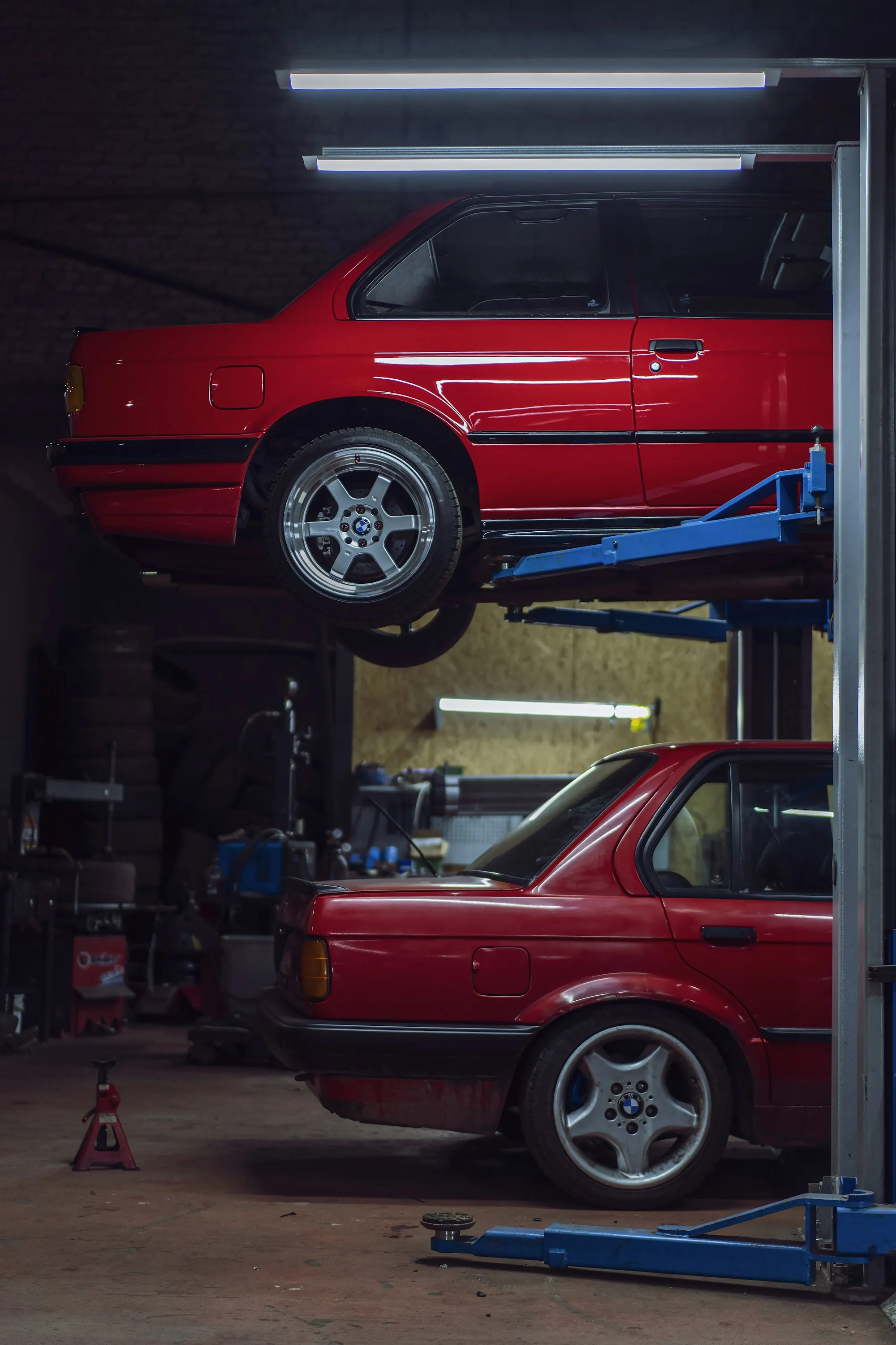 Inside a repair workshop with a car on a lift